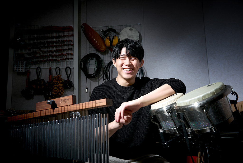 다양한 브라질 악기로 채워진 작업실에서, 이성재 퍼커셔니스트가 한쪽 팔을 봉고에 올린 채 정면을 응시하고 있다. 앞쪽으로 윈드벨이 놓여 있고, 뒤편 벽에는 작은 손북 등 다양한 브라질 타악기가 걸려 있다.
이성재 퍼커셔니스트